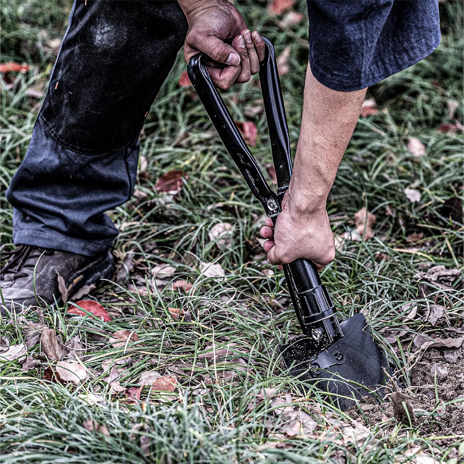 Camping shovel digging into soil during outdoor adventure, ideal for backpacking first aid kit and hiking emergency kit